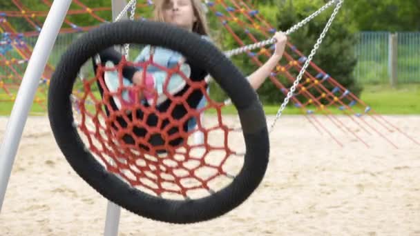 Teen girl on swing — Stock Video