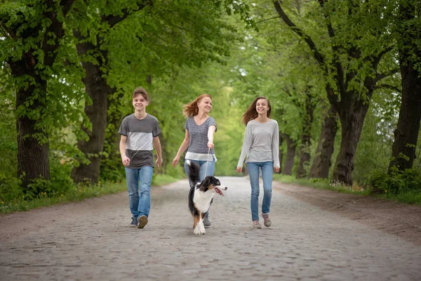 Happy family with dog on road