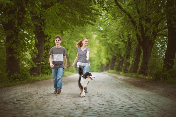 Happy family with dog on road