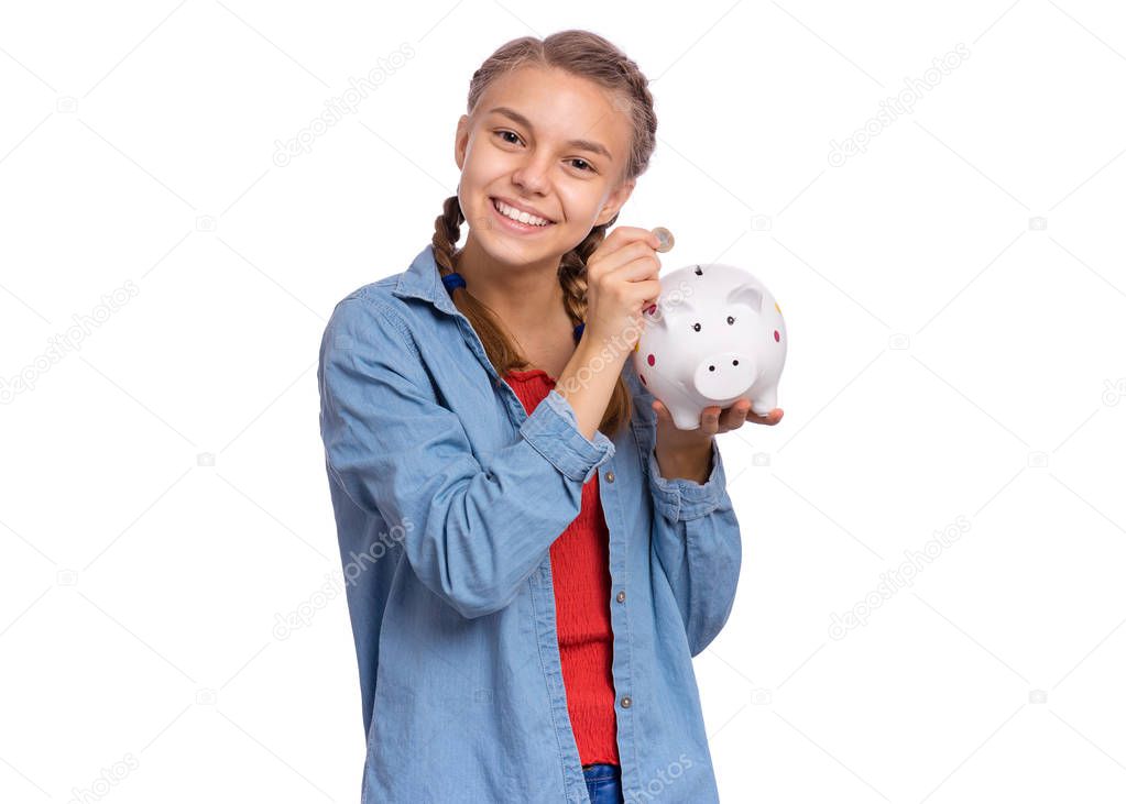 Teen girl holding piggy bank