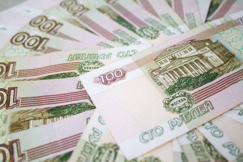 business, finance, saving, banking and people concept - close up bundle of money Russian Banknotes one hundred rubles