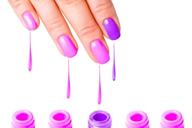 Beauty, fashion and Nail art concept - Woman hand close-up with five bottles of pink and purple gel nail polish and drops from fingers. isolated on white background. copy space clipart