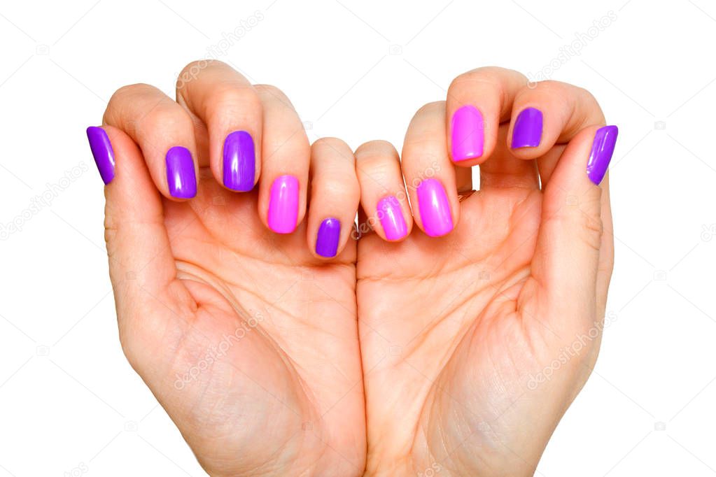 Beauty, fashion and Nail art concept - Heart made of woman hands whith shiny manicure close-up. Pink and purple colors of gel nail polish. isolated on white background.