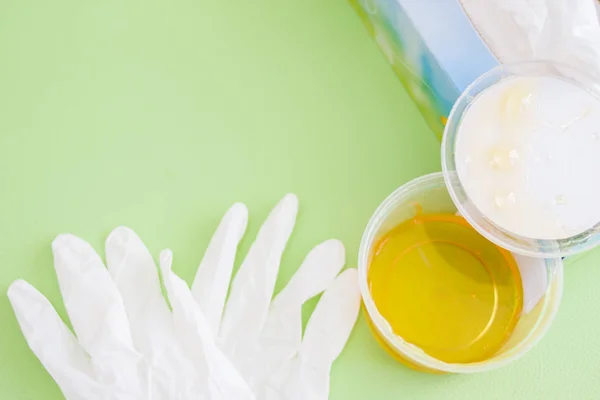 depilation and beauty concept - sugar paste or wax honey for hair removing with white gloves. copyspace