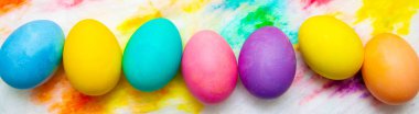 Renkli Paskalya yumurta çerçeve kenarlığı çok renkli boyalı arka plan üzerinde. üstten görünüm, boşaltmak.