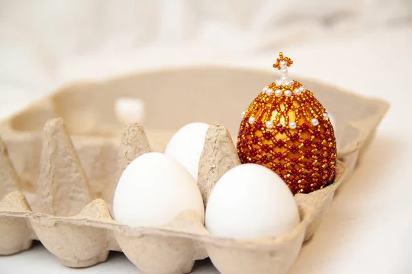 Resurrection of Jesus Christ. Religious Easter background, with three wrhite egg in box and color egg with cross on top. White background