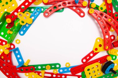 Metin için çerçeve. Üstten Görünüm çok renkli çocuklar oyuncak inşaat beyaz arka plan üzerinde tuğla engeller. Copyspase. düz yatıyordu. Masanın üzerinde çocuk oyuncakları