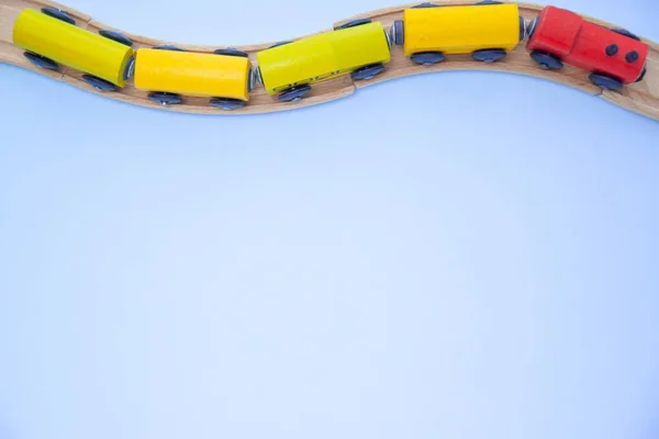 Top view on multicolor kids toy train cars bricks on wooden railway blue background. Copyspase. flat lay. Children toys on the table — Stock Photo, Image