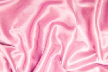 Tekstil ve doku kavramı - buruşuk ipek pembe dalgalı kumaş arka plan yakın.