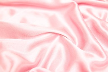 Tekstil ve doku kavramı - buruşuk ipek pembe dalgalı kumaş arka plan yakın.