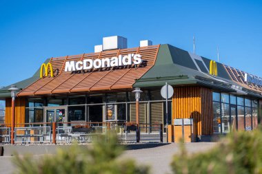 McDonalds restaurant exterior. View of the fast food restaurant on sunny day. FInland, Vantaa, 28feb2020 clipart