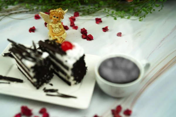 angle doll with valentine cake and coffee in romantic lights