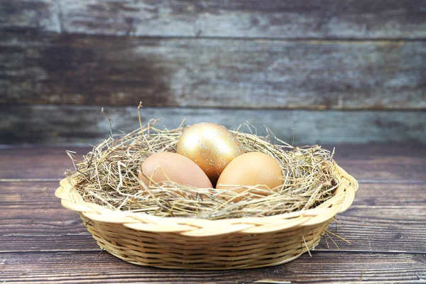 golden  eggs and normal egg in the basket