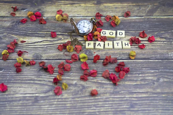dry flower and god and pocket watch and faith  spelling for back