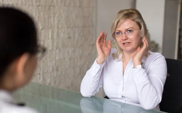 Blonde woman on job interview in office answering