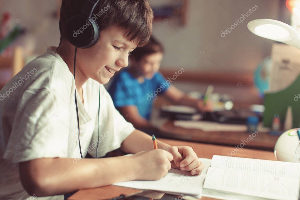 Young boys doing homework or learning at home 