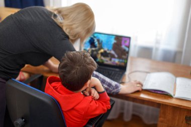 Mother turning off computer for computer addicted little gamer kid, internet and game dependency clipart