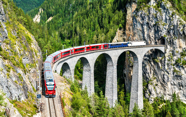 Passenger train crossing the Landwasser Viaduct in Switzerland