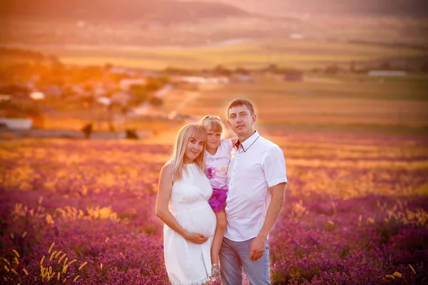 Happy family in white clothes in the lavender field.