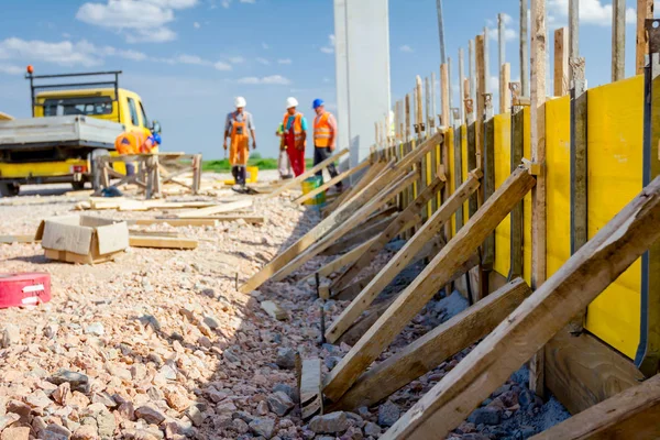 Uzun ahşap kalıp montajı ve yapı duvar temeli betonlama için hazır.