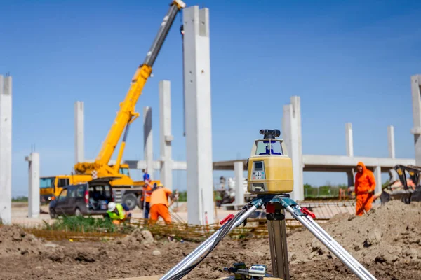 Total center device with laser for leveling other devices to level construction site.