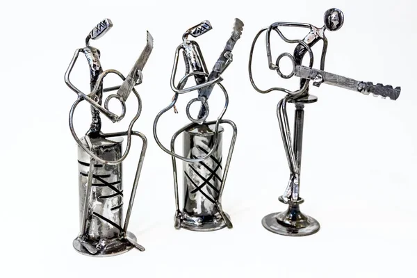 Figures of music performers made with welded black metal wire, guitarists are playing together living lines.