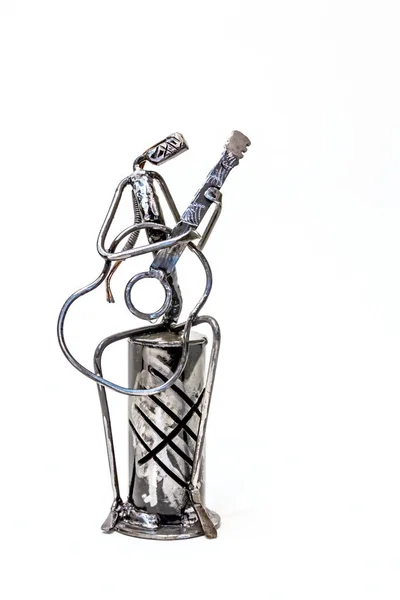 Figure of music performer made with welded black metal wire, guitarist playing solo, living lines.