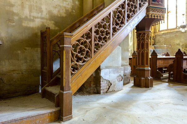 Staircase with decorative wooden banister for altar on balcony in ancient German Catholic church, Cathedral.