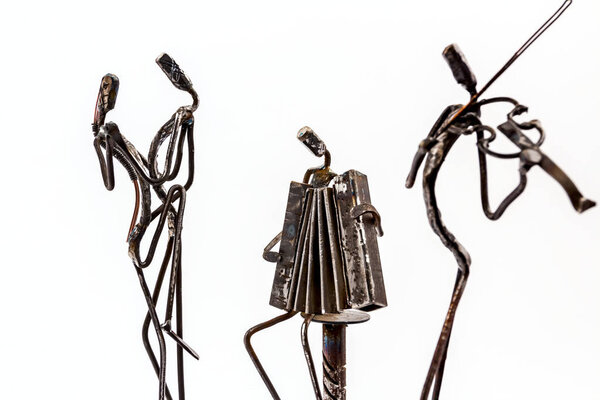 Figures of music performers made with welded black metal wire. Accordion and violin are playing together. Dancers are dancing stylish with sexy passion. Living lines