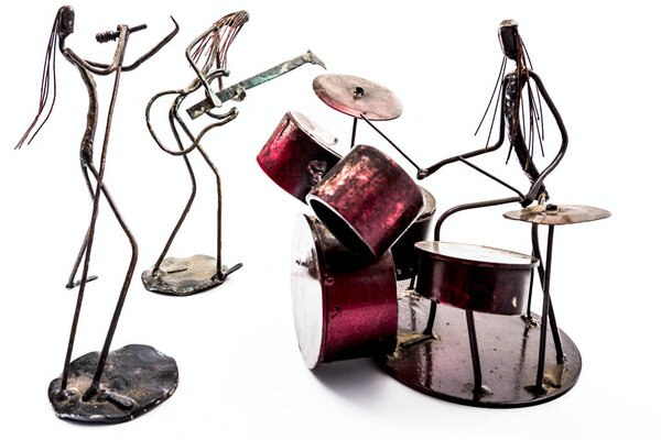 Figures of music performers made with welded black metal wire. Band made of: guitarist, drummer and singer are playing together. Living lines