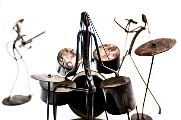 Figures of music performers made with welded black metal wire. Band made of: guitarist, drummer and singer are playing together. Living lines