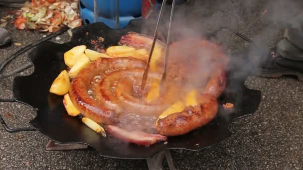 Hand Help Metal Tongs Turns Simmering Potatoes Sausages Black Barbecue — Stock Video