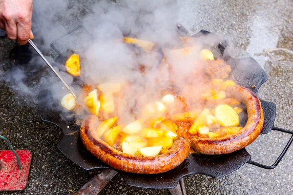 View Smoke Hand Metal Tongs Turns Simmering Potatoes Sausages Barbecue — Stock Photo, Image