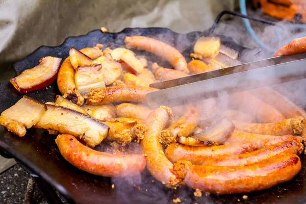 Hand Help Metal Tongs Turns Simmering Sausages Black Barbecue Grill — Stock Photo, Image