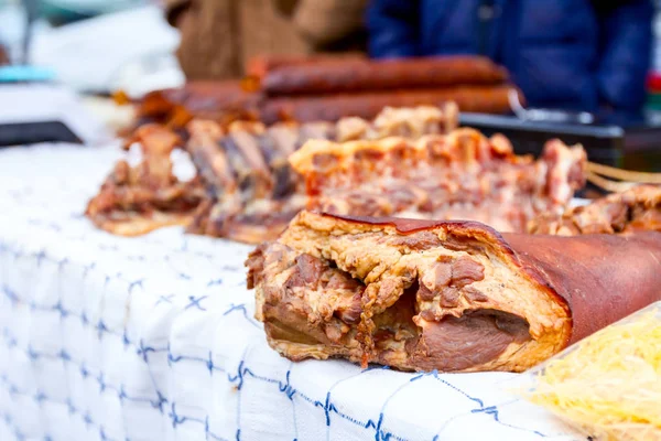 Bunch of smoked, dried pig bones and knuckles are for sale at outdoor flea market.