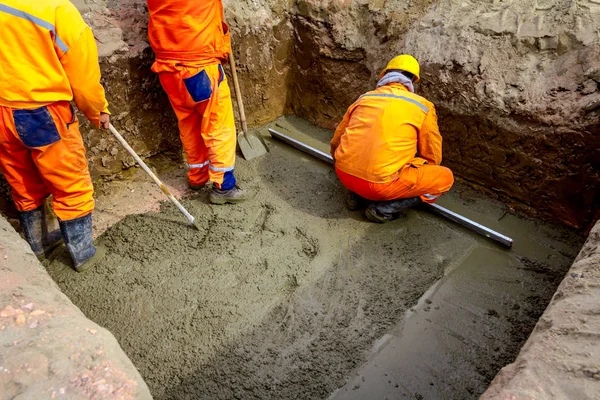 Рабочий выравнивает бетон после заливки — стоковое фото