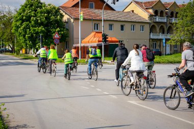 Bisiklet süren, şehirde bisiklete binen, kalabalık içinde araba kullanan bir grup genç, trafikteki ve kentsel çevredeki bisikletçiler için tehlikelere dikkat çekmeye çalışıyor.. 