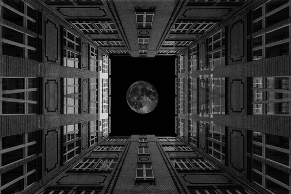 Residential houses in Berlin , with inserted moon