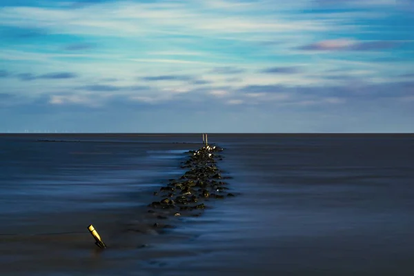 Long time exposure of the North Sea at Cuxhaven with fast flying clouds