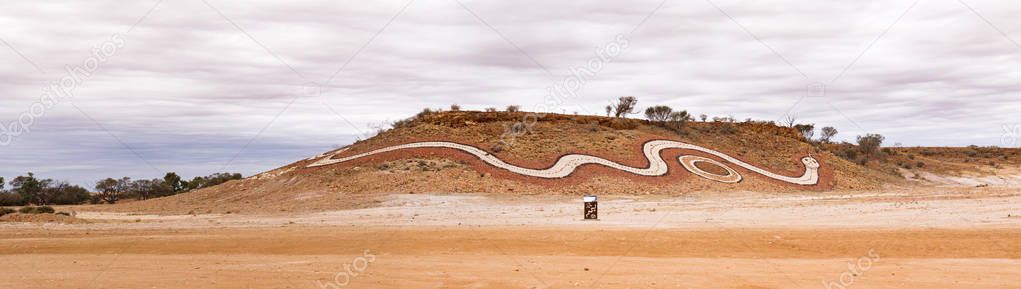 Indigenous artwork of a dreamtime serpent on a hill at Betoota, south-west of Longreach in far-west Queensland public artworks to tell women's Dreamtime stories of the Mithika, Wangkamadla and Wangkangurru people