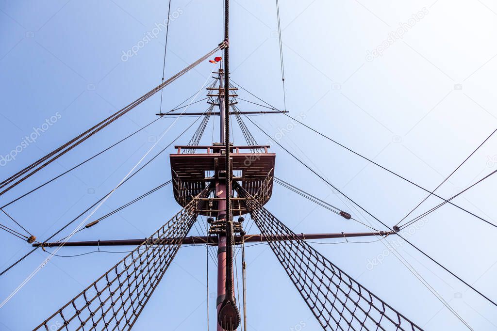 classic tall ship with rope rigging and sails. and crows nest