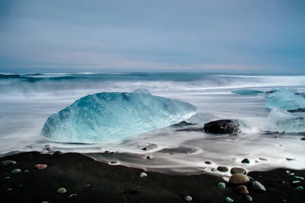 Iceberg laying on a black sand beach in Iceland — Stock Photo, Image