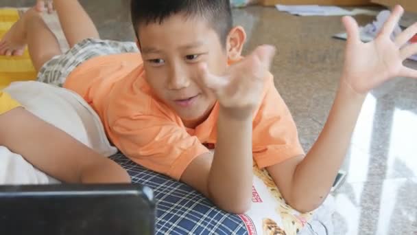 Gelukkige Kinderen Tot Vloer Kijken Naar Zijn Vriend Speelspel Laptop — Stockvideo