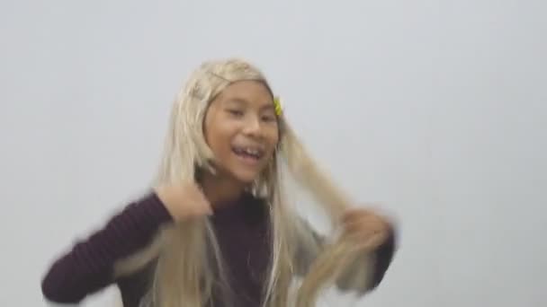 Aziatisch Meisje Met Lang Blond Haar Pruik Haar Blik Veranderen — Stockvideo