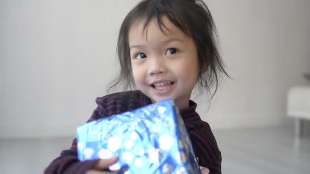 Asian Baby Girl Holding Christmas Gifts — Stock Video