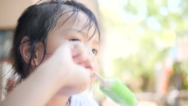 Asian Girl Eating Ice Cream Outdoor — Stock Video