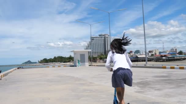 Asian Girl Playing Stunt Scooter Hua Hin Pier Sunny Day — Stock Video