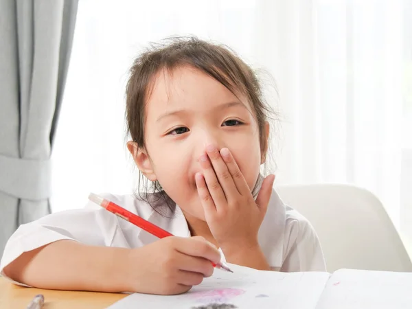 Yawing Asian Girl While Doing Homework Home — Stock Photo, Image
