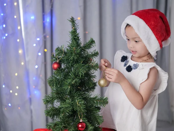 Happy Asian Girl Santa Hat Decorating Christmas Tree Home — Stock Photo, Image