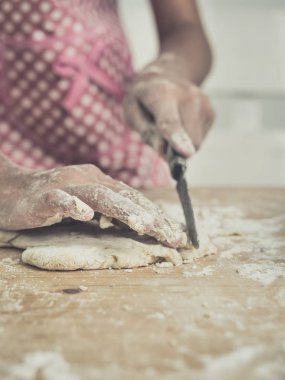 Kız masanın üzerine hamur kesme eller.